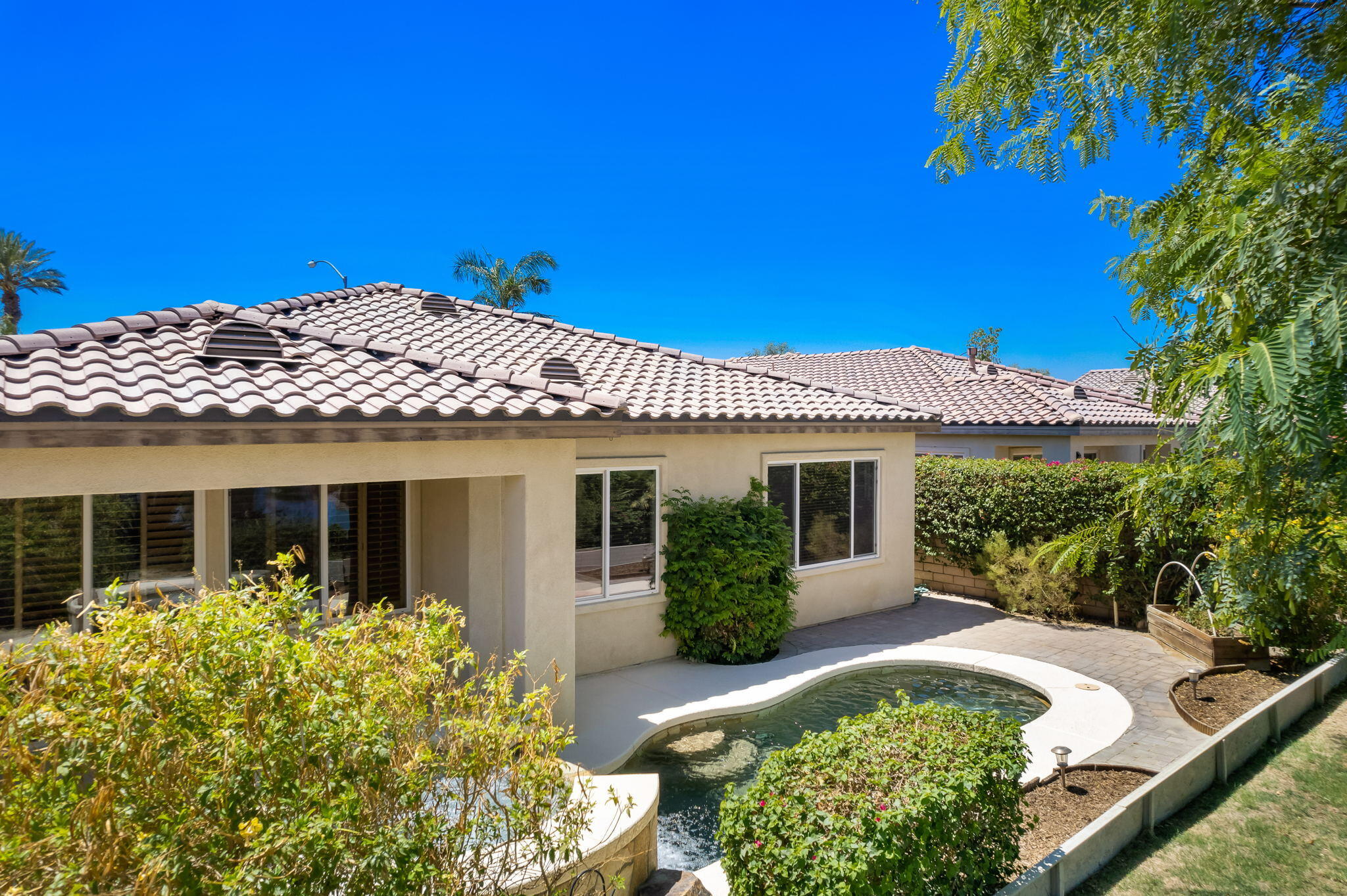 49728 Pacino Street Indio, CA 92201 - Photo 6 of 54 a front view of a house with a yard