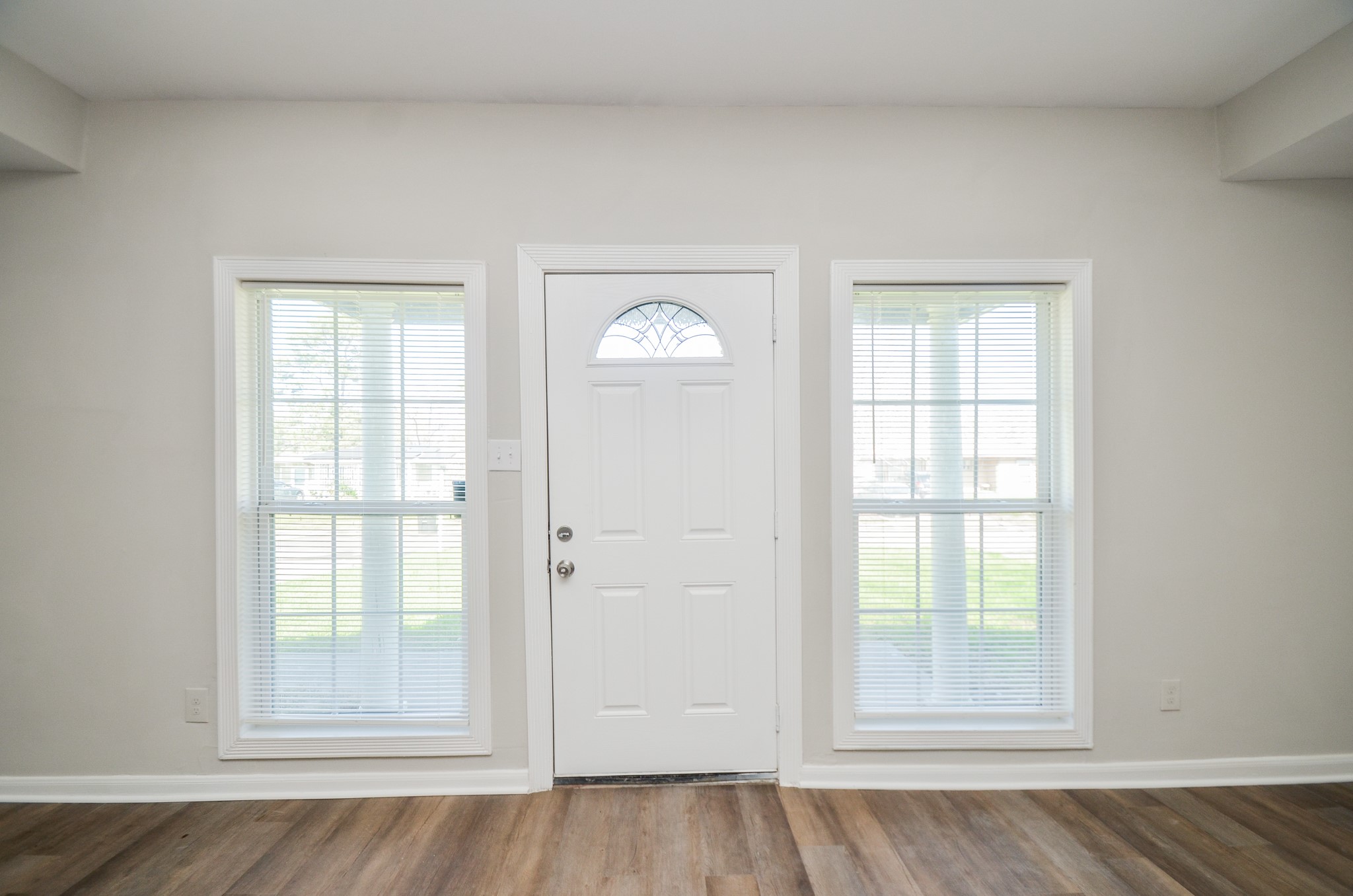5238 Keystone Street Houston, TX 77021 - Photo 3 of 31 Bright entryway featuring a white front door centered between large windows, filling the space with natural light.