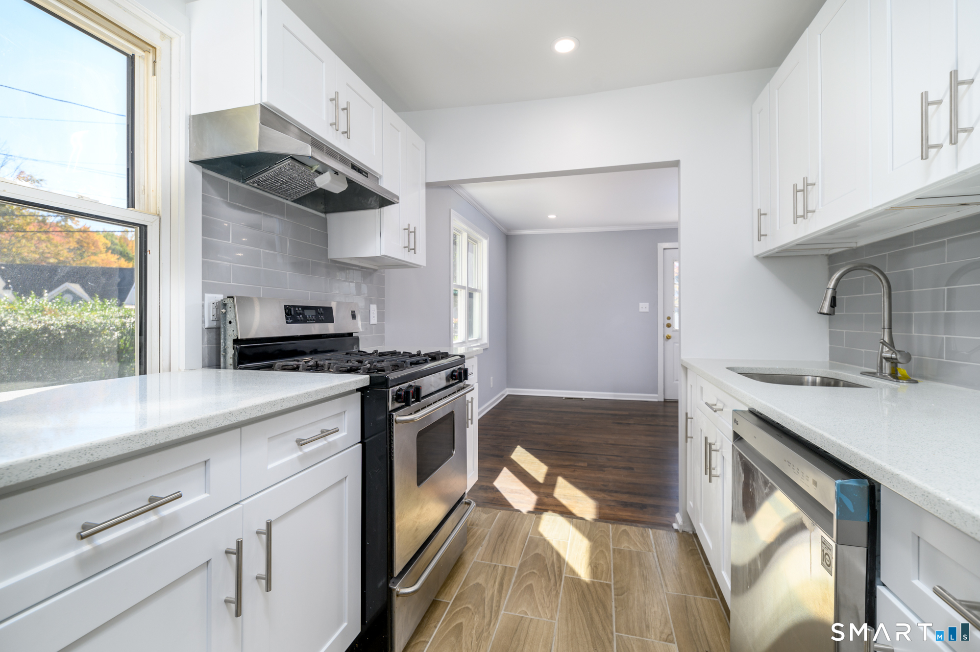 40 Beacon View Drive, Unit 2 Fairfield, CT 06825 - Photo 5 of 18 a kitchen with stainless steel appliances a sink stove and refrigerator