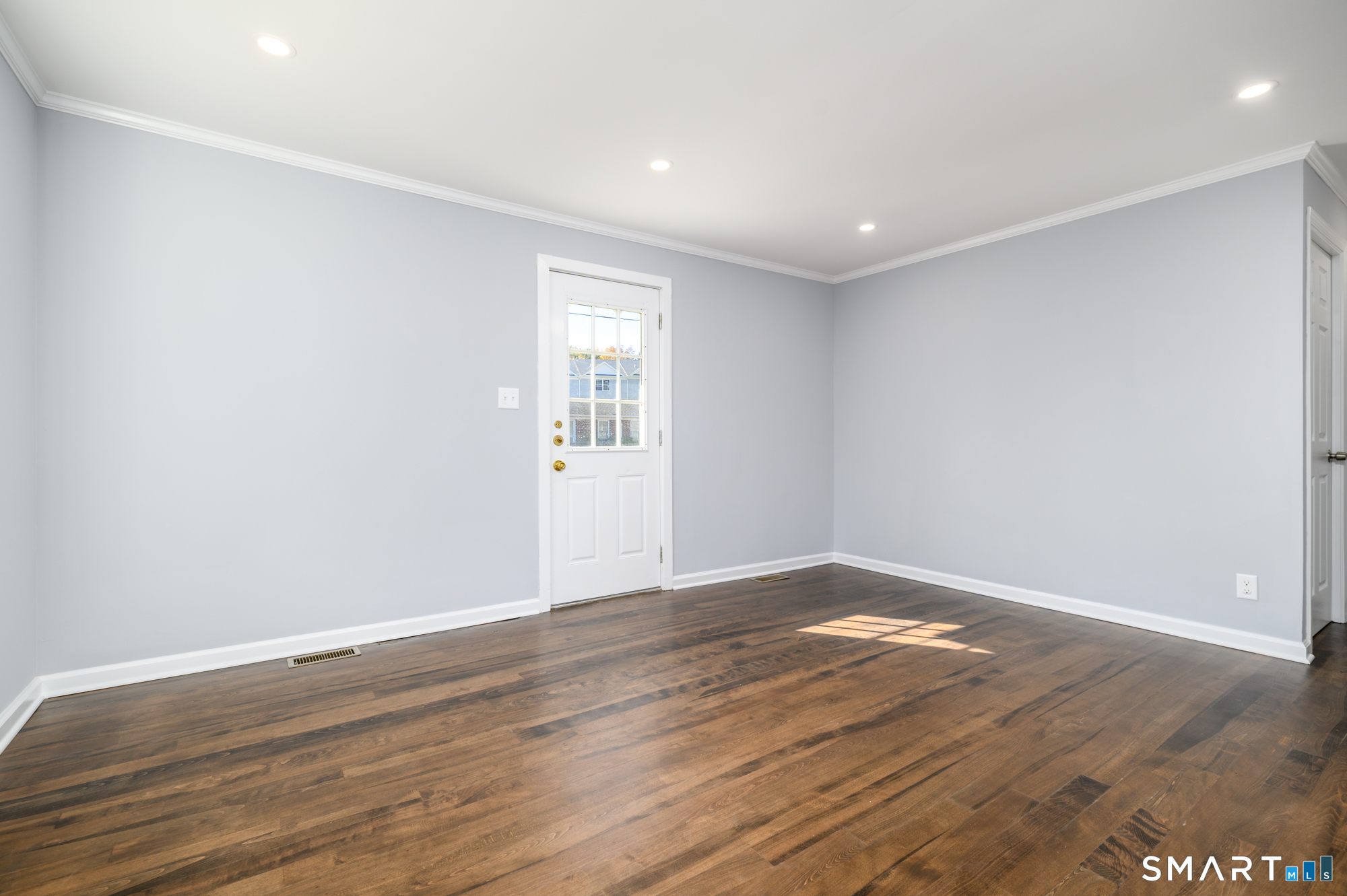 40 Beacon View Drive, Unit 2 Fairfield, CT 06825 - Photo 6 of 18 a view of empty room with wooden floor and fan