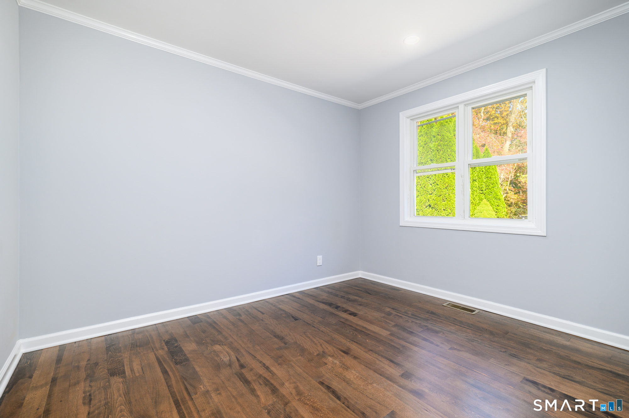 40 Beacon View Drive, Unit 2 Fairfield, CT 06825 - Photo 7 of 18 a view of an empty room with wooden floor and a window
