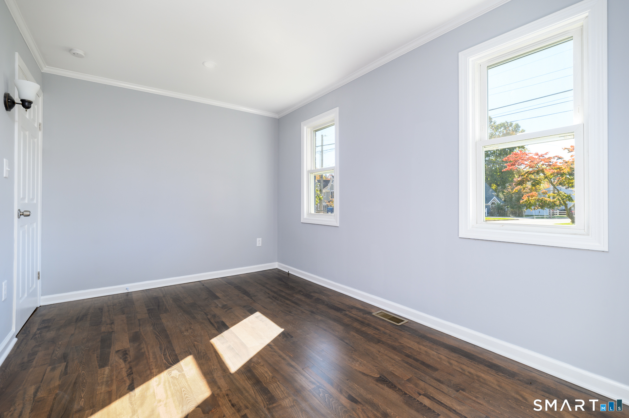 40 Beacon View Drive, Unit 2 Fairfield, CT 06825 - Photo 8 of 18 an empty room with wooden floor and windows