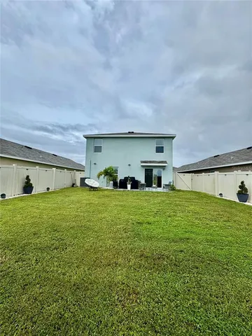 a front view of house with yard and outdoor seating