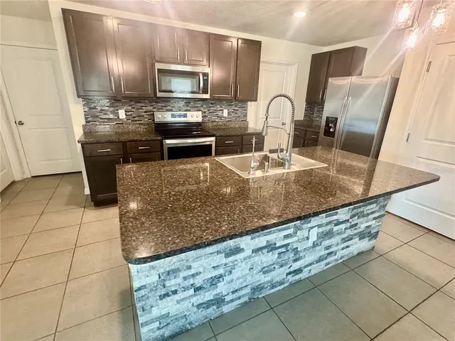 a spacious bathroom with a double vanity sink and mirror