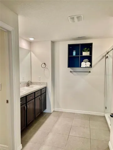 a bathroom with a glass shower door