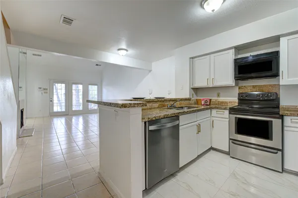a kitchen with a sink and cabinets