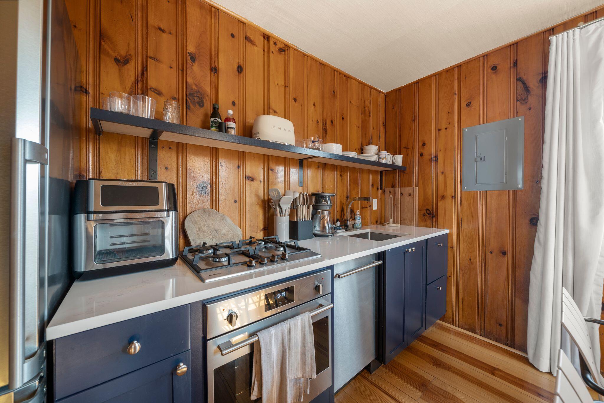 18 Manning Road Dennis Port, MA 02639 - Photo 11 of 34 a kitchen with stainless steel appliances granite countertop a stove and a refrigerator