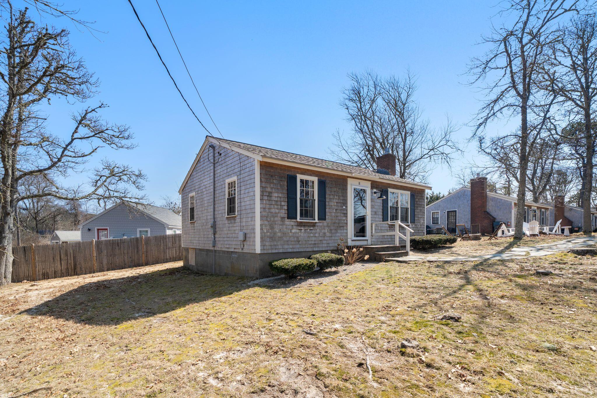 18 Manning Road Dennis Port, MA 02639 - Photo 2 of 34 a front view of a house with a yard covered with snow