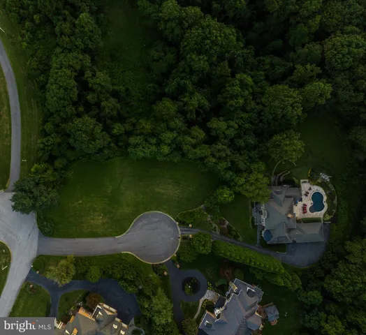 an aerial view of a house with garden space and lake view