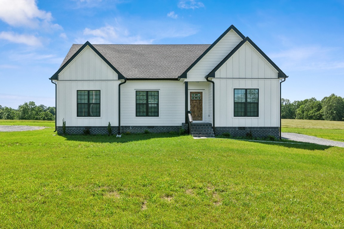 5129 Galen Road Lafayette, TN 37083 - Photo 1 of 25 a front view of a house with a yard and garage