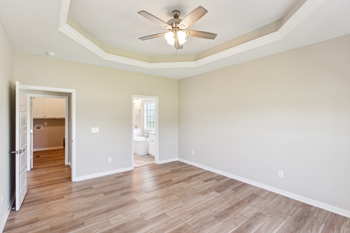 5129 Galen Road Lafayette, TN 37083 - Photo 12 of 25 an empty room with wooden floor and a ceiling fan