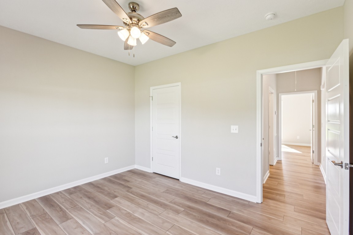 5129 Galen Road Lafayette, TN 37083 - Photo 20 of 25 a view of a room with wooden floor and a ceiling fan