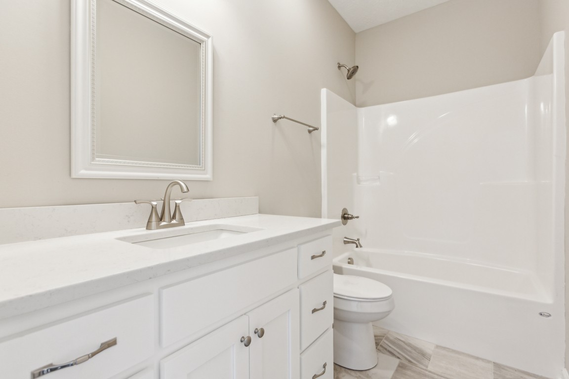5129 Galen Road Lafayette, TN 37083 - Photo 21 of 25 a bathroom with a granite countertop sink toilet a large mirror and shower