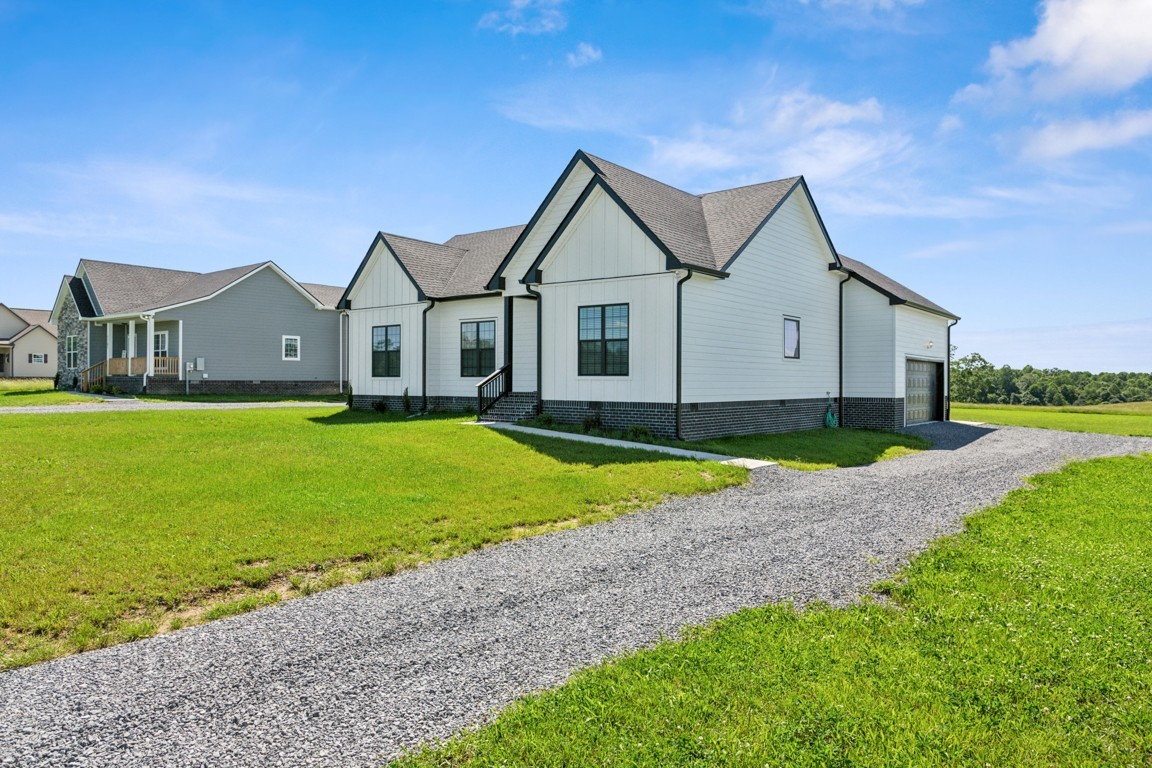 5129 Galen Road Lafayette, TN 37083 - Photo 3 of 25 a view of a house with a big yard and large trees