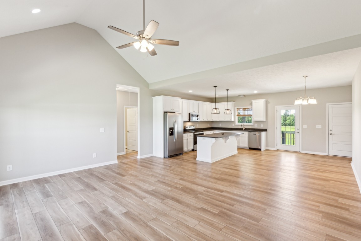 5129 Galen Road Lafayette, TN 37083 - Photo 4 of 25 a view of an empty room with wooden floor and a kitchen