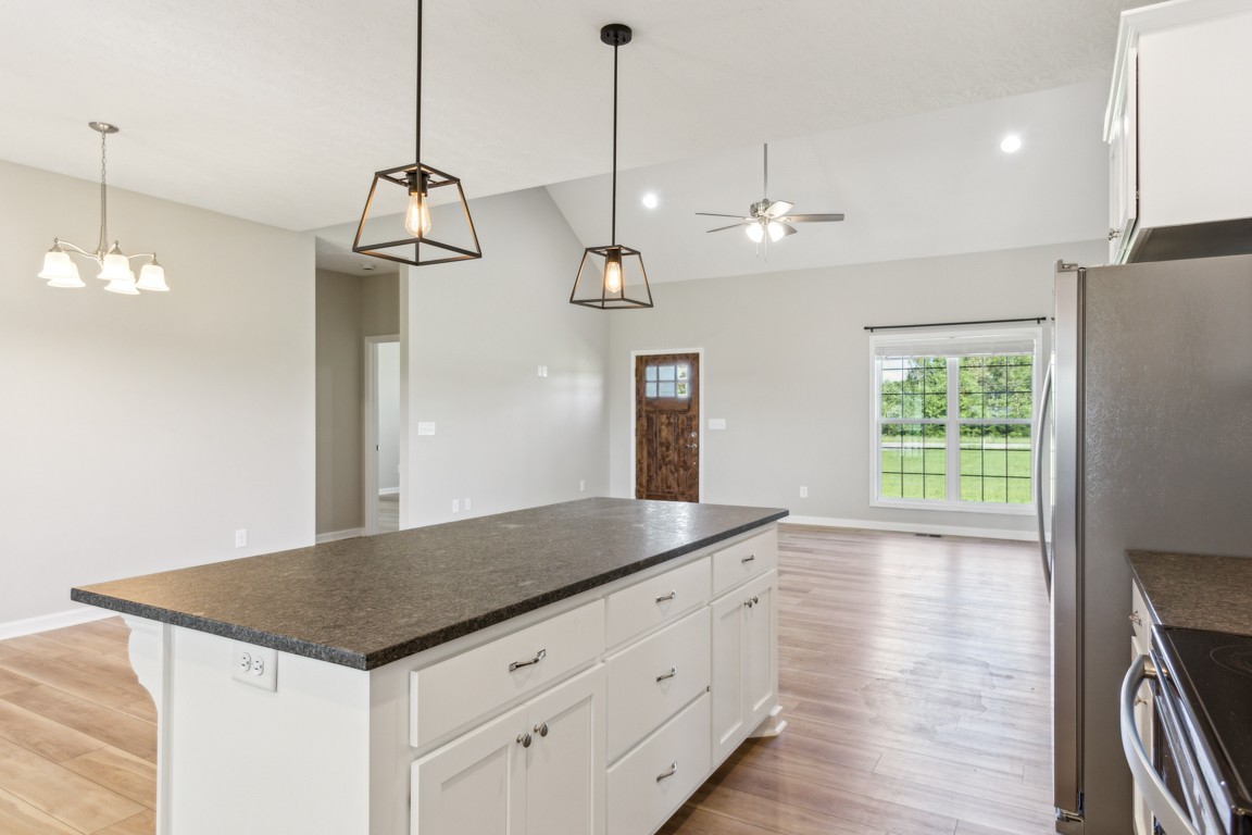 5129 Galen Road Lafayette, TN 37083 - Photo 9 of 25 a kitchen with kitchen island white cabinets and wooden floor