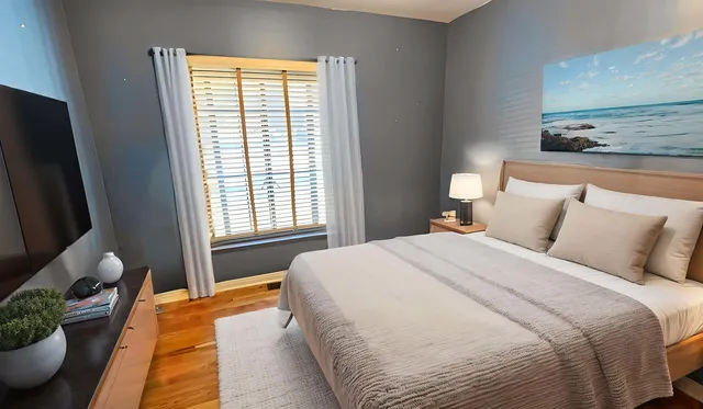 a view of an empty room with wooden floor