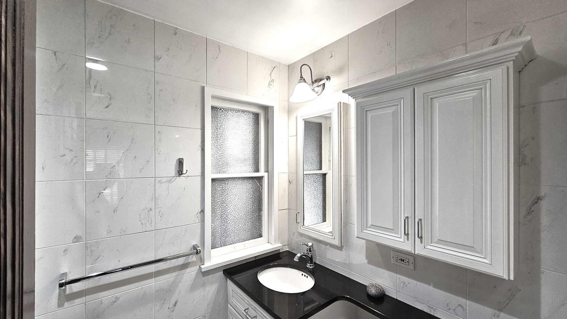 410 North Raynor Avenue, Unit 1W Joliet, IL 60435 - Photo 19 of 64 a bathroom with a sink and a mirror