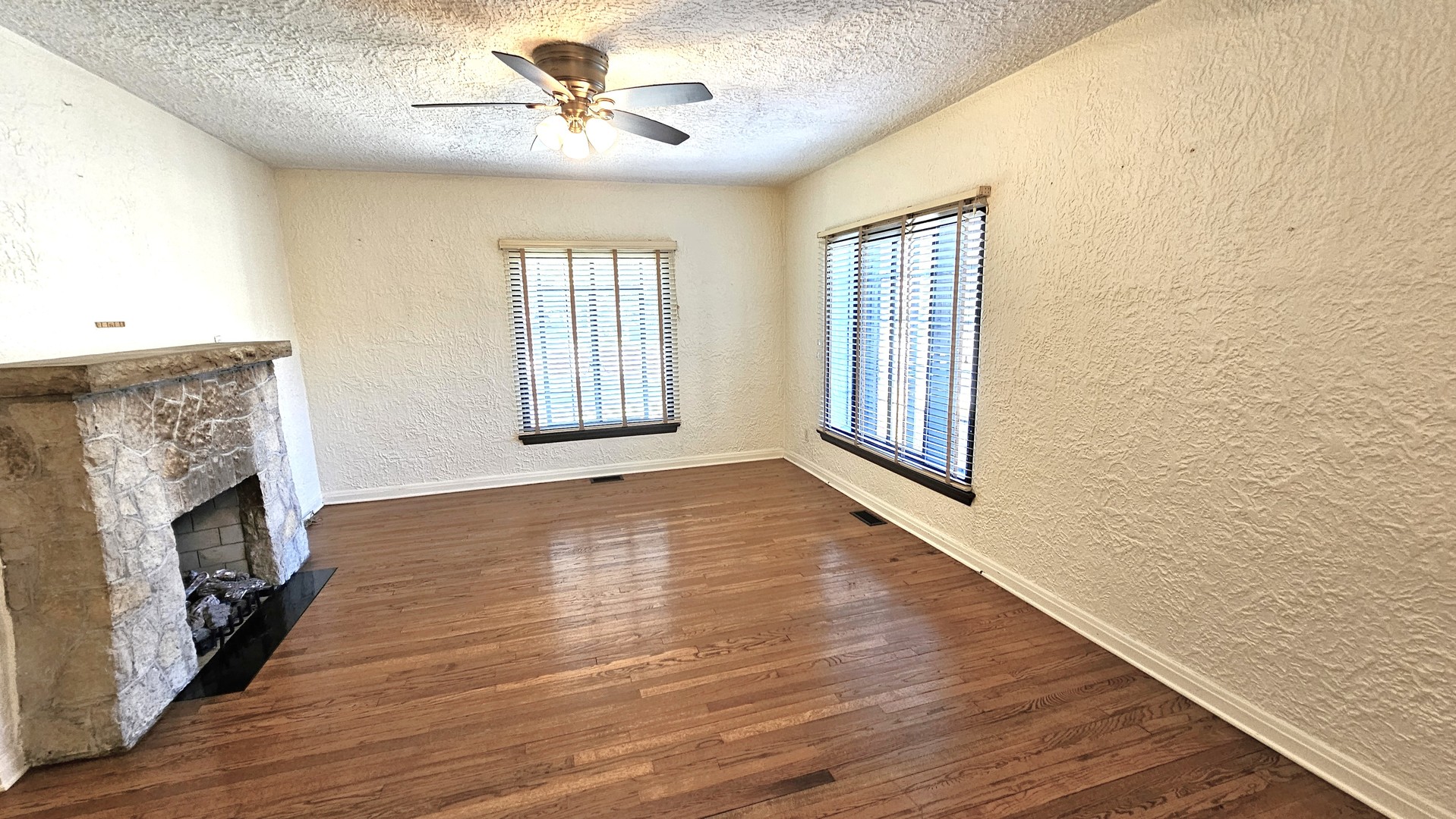 410 North Raynor Avenue, Unit 1W Joliet, IL 60435 - Photo 28 of 64 a view of an empty room with a window and fireplace