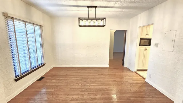 a bedroom with bed and a potted plant