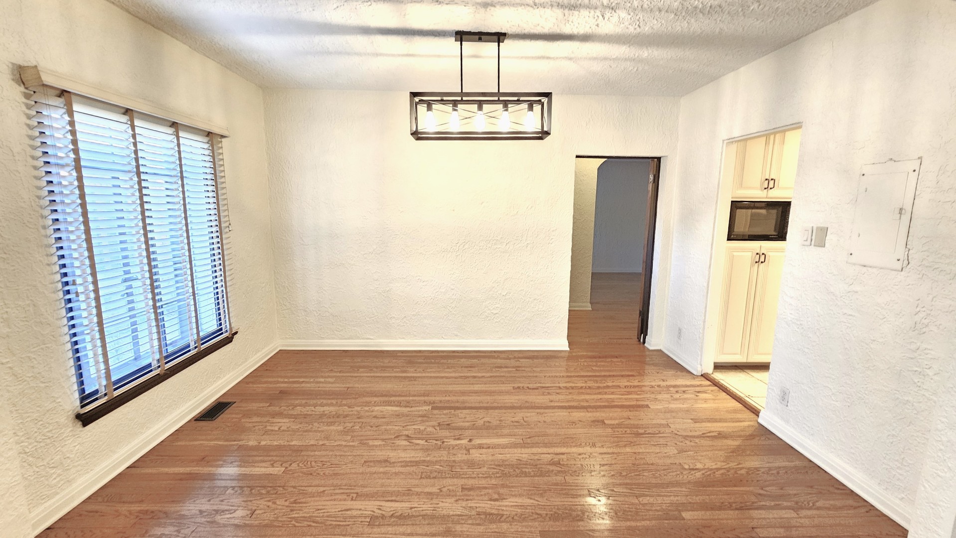 410 North Raynor Avenue, Unit 1W Joliet, IL 60435 - Photo 30 of 64 a view of a hallway with windows and chandelier
