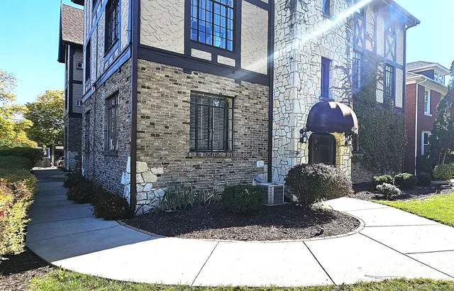 a front view of a residential apartment building with a yard