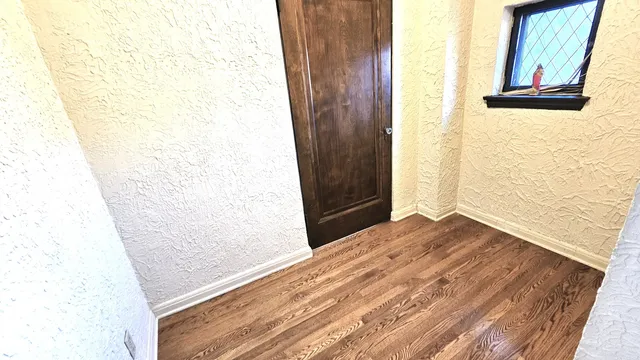 a spacious bedroom with a bed and glass door