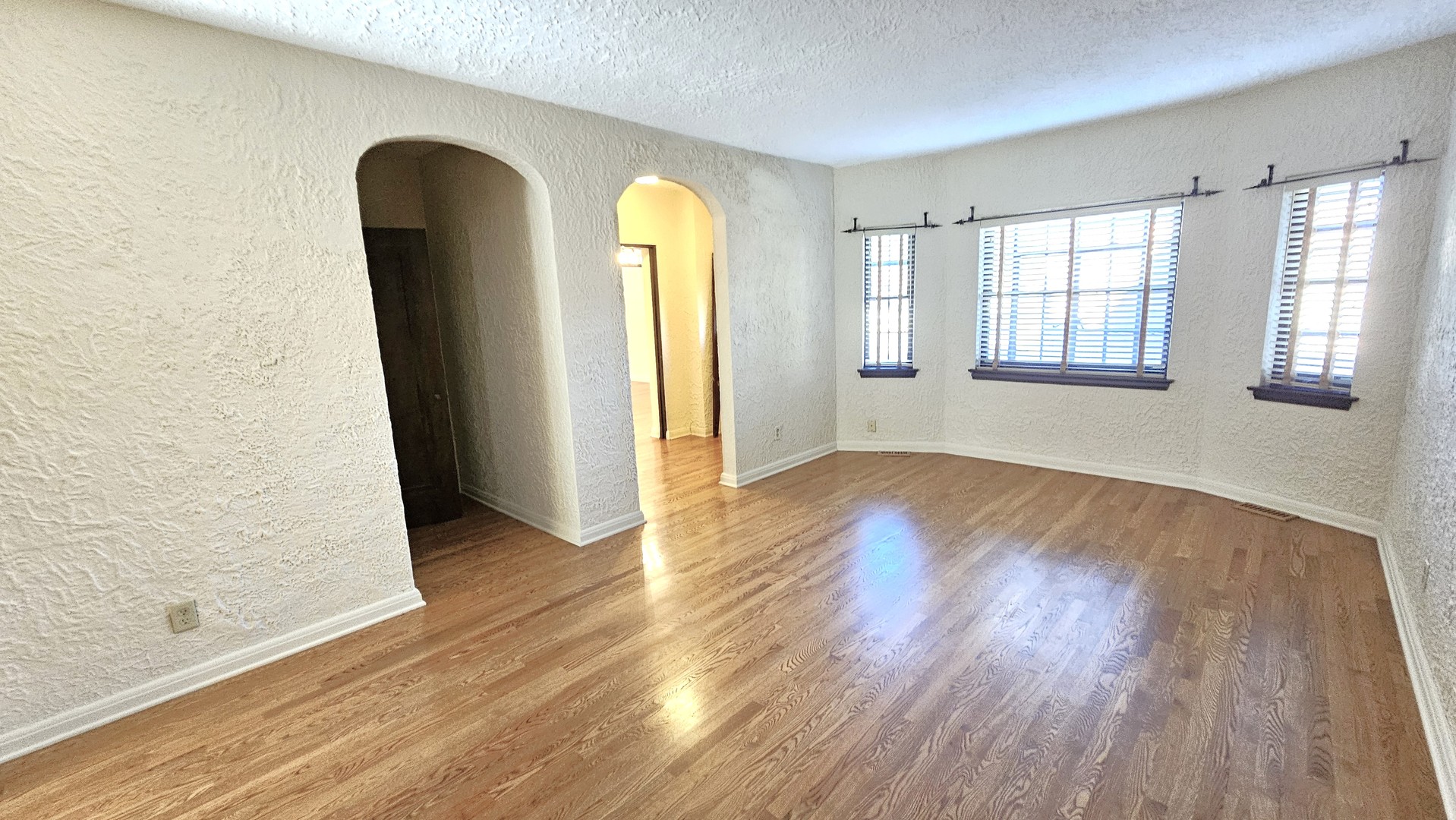 410 North Raynor Avenue, Unit 1W Joliet, IL 60435 - Photo 34 of 64 an empty room with wooden floor and windows