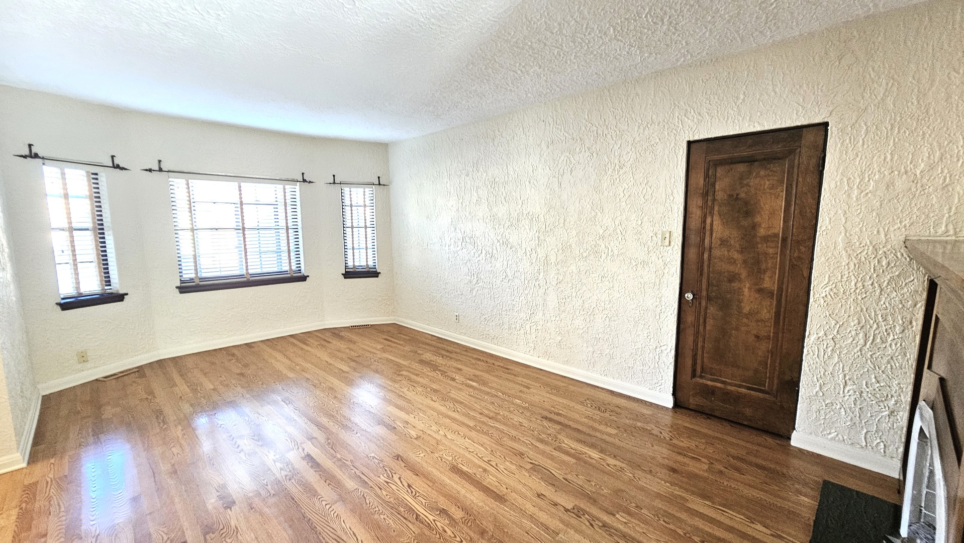 410 North Raynor Avenue, Unit 1W Joliet, IL 60435 - Photo 35 of 64 an empty room with wooden floor and windows