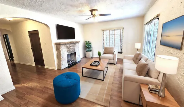 a living room with furniture fireplace and a flat screen tv