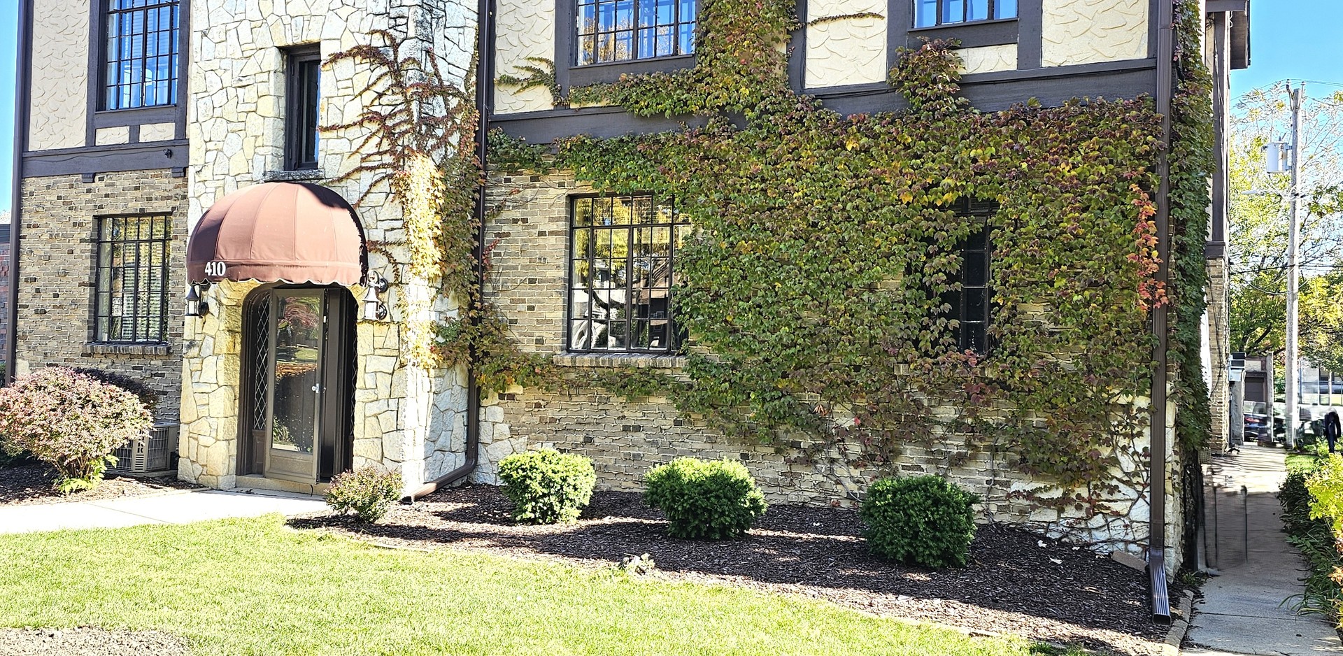 410 North Raynor Avenue, Unit 1W Joliet, IL 60435 - Photo 4 of 64 a front view of a house with a yard