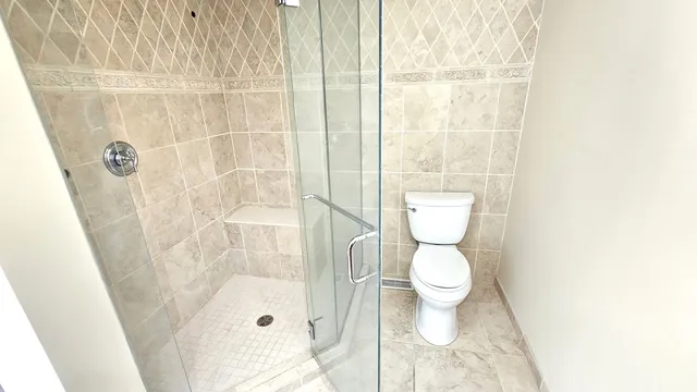 a view of a bathroom with mirror and door