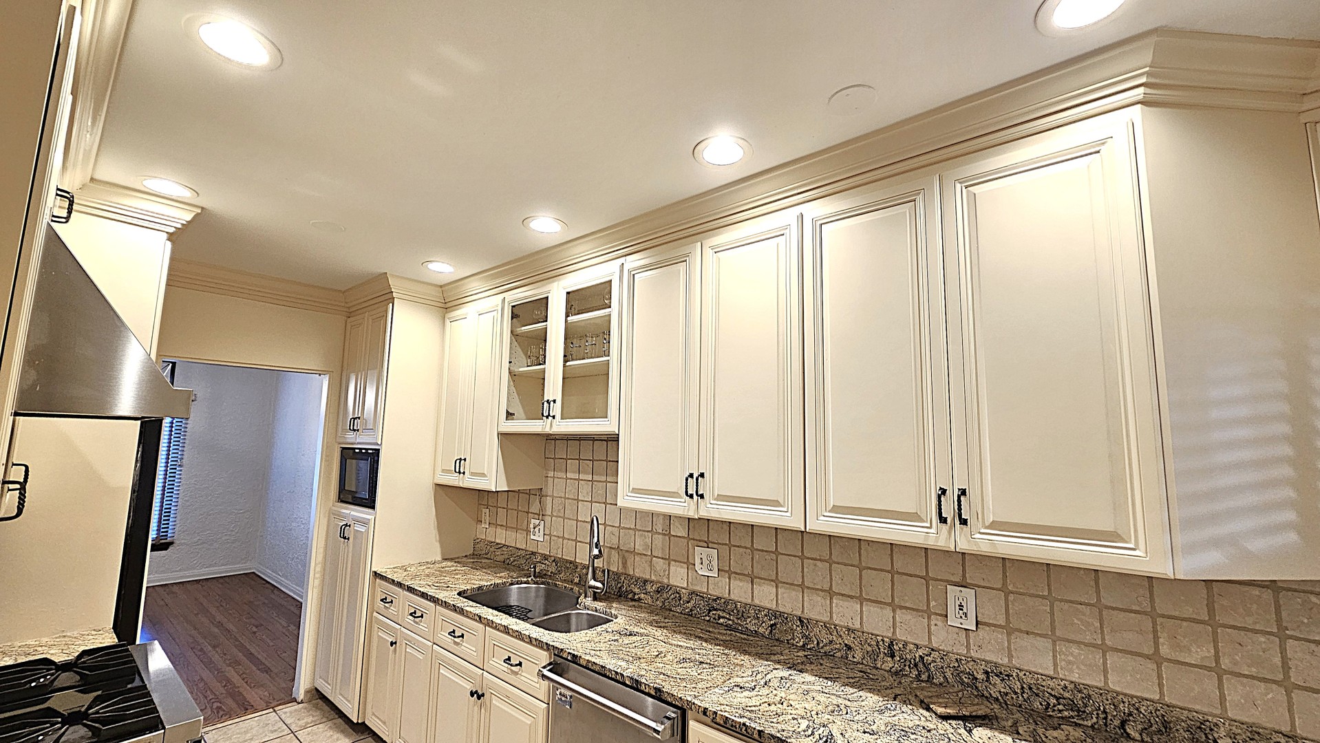 410 North Raynor Avenue, Unit 1W Joliet, IL 60435 - Photo 47 of 64 a kitchen with stainless steel appliances granite countertop a stove a sink and a refrigerator