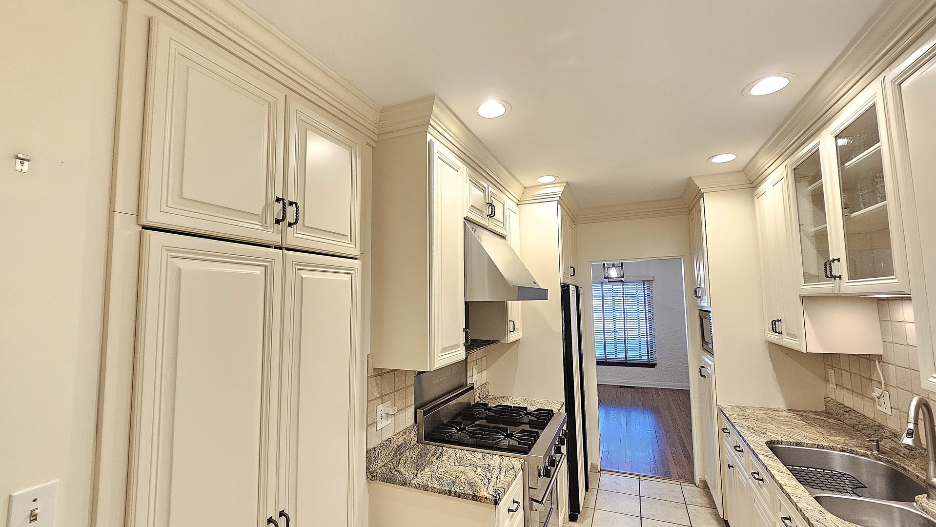 410 North Raynor Avenue, Unit 1W Joliet, IL 60435 - Photo 49 of 64 a kitchen with stainless steel appliances granite countertop a stove and a refrigerator