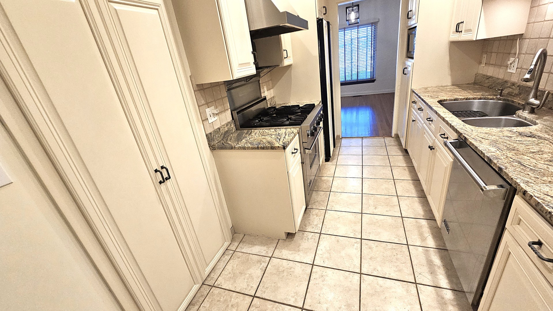410 North Raynor Avenue, Unit 1W Joliet, IL 60435 - Photo 50 of 64 a kitchen with stainless steel appliances granite countertop a stove a sink and a refrigerator