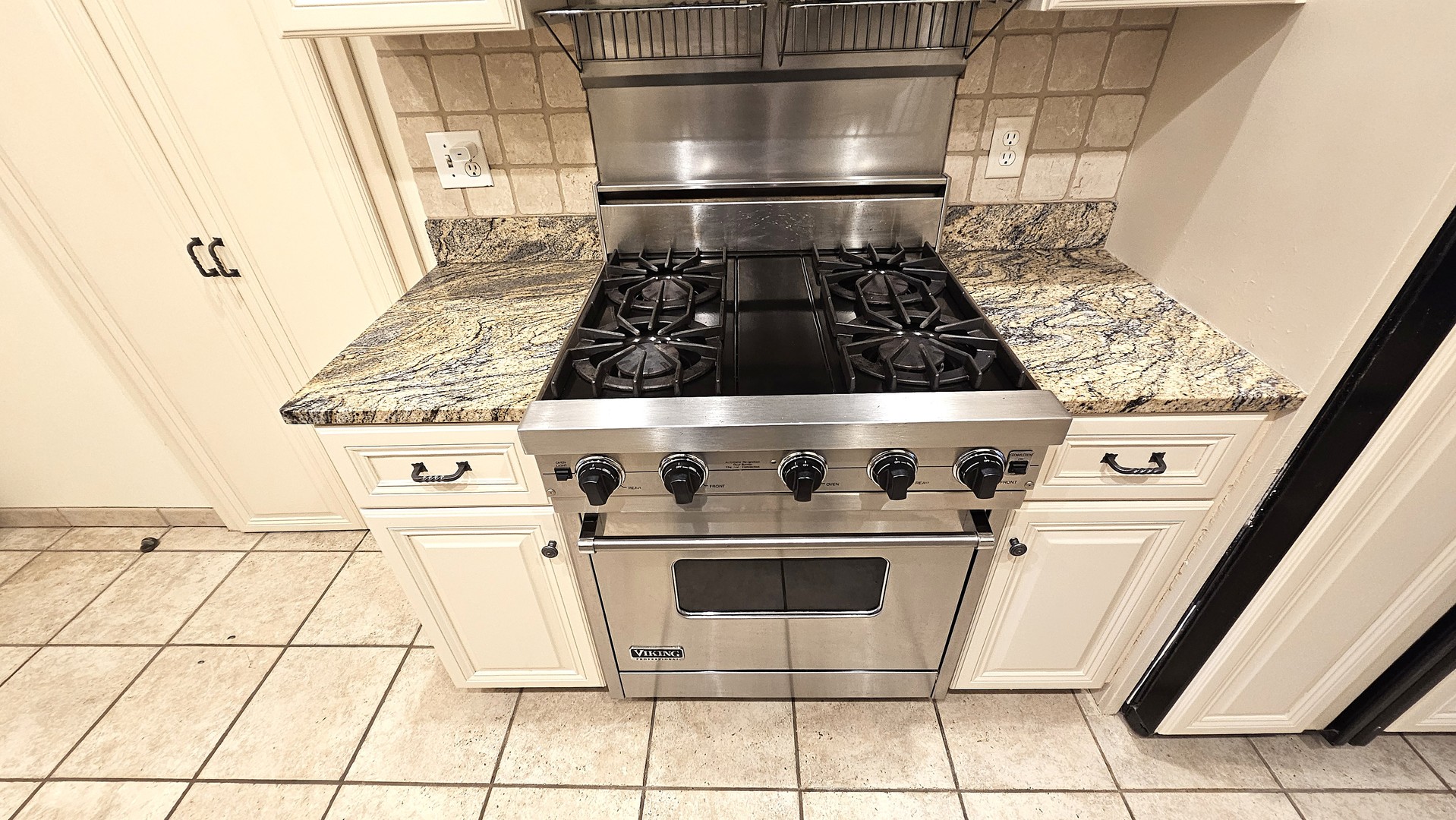 410 North Raynor Avenue, Unit 1W Joliet, IL 60435 - Photo 52 of 64 a close view of a stove top oven and cabinets