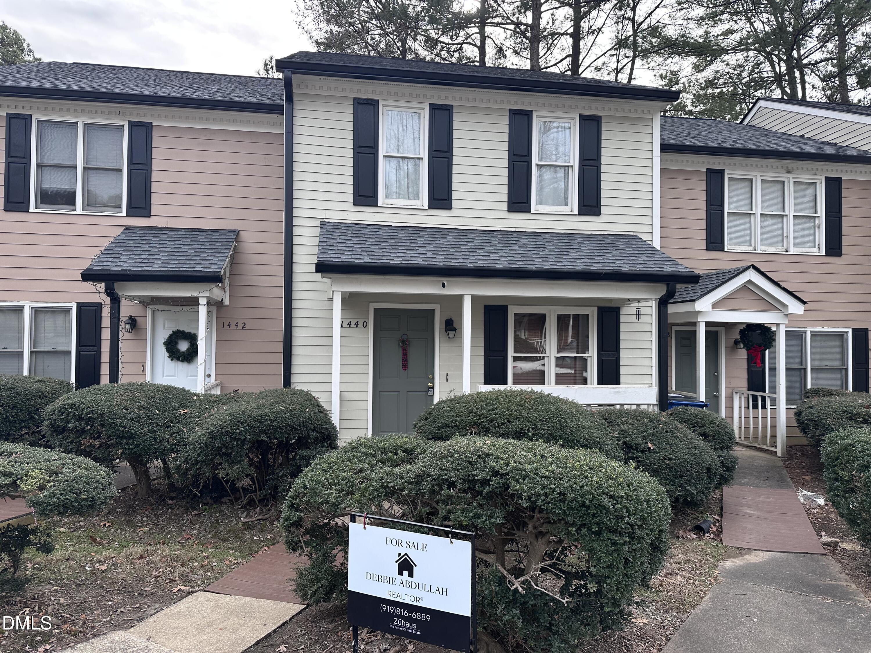 a front view of a house with a garden
