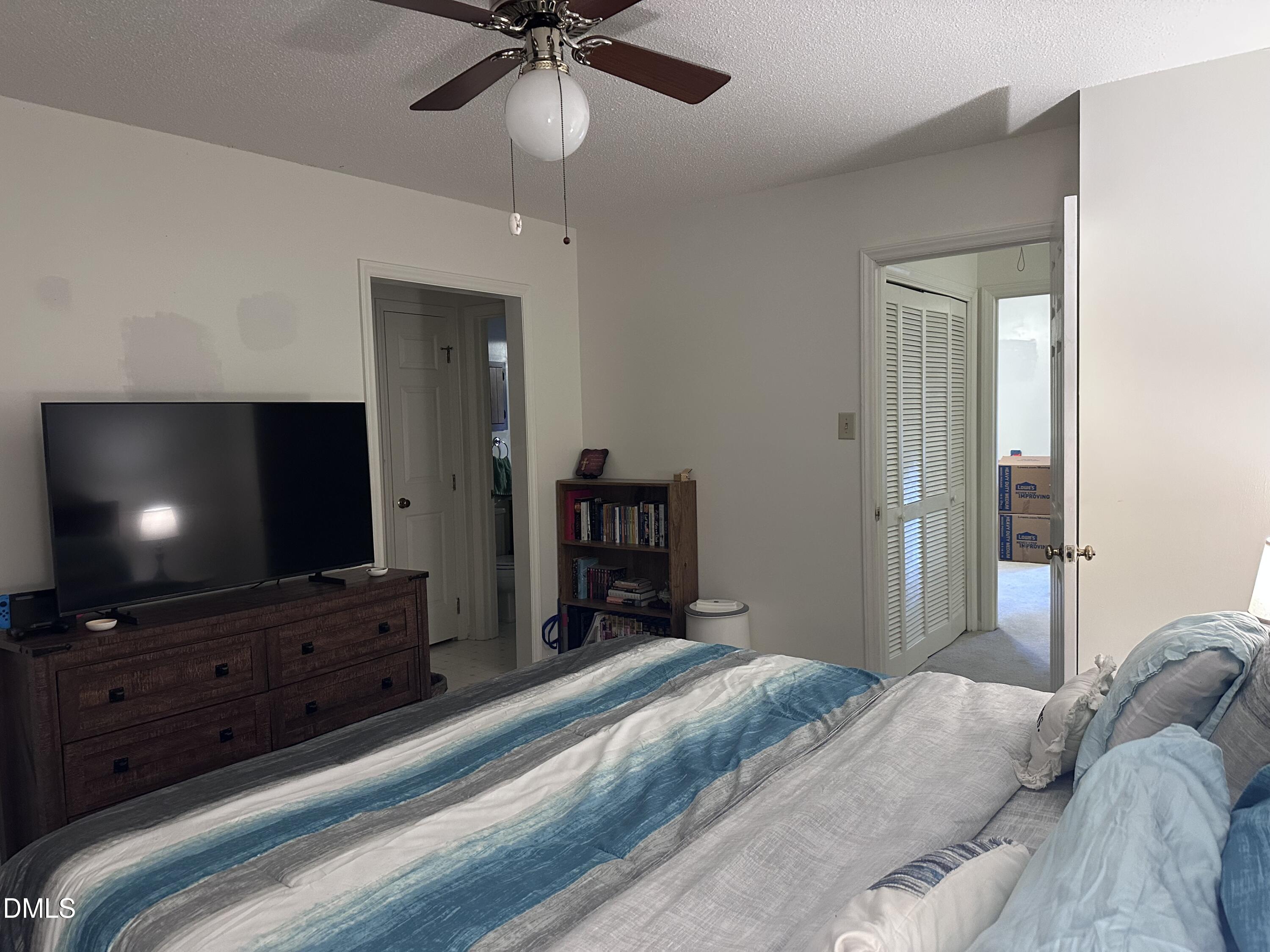 1440 Kent Road Raleigh, NC 27606 - Photo 12 of 21 a bedroom with a bed and a flat screen tv