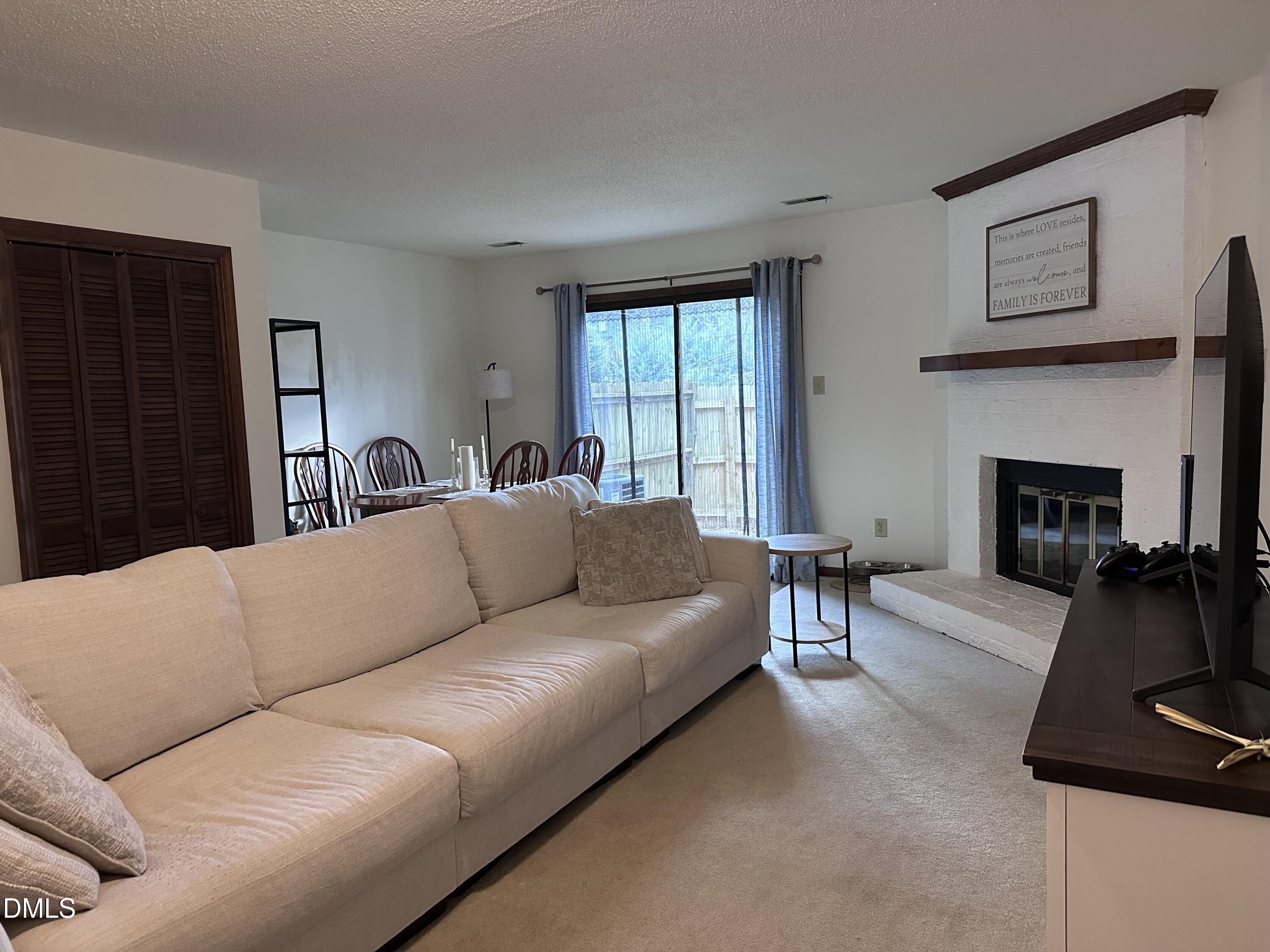1440 Kent Road Raleigh, NC 27606 - Photo 3 of 21 a living room with furniture and a fireplace