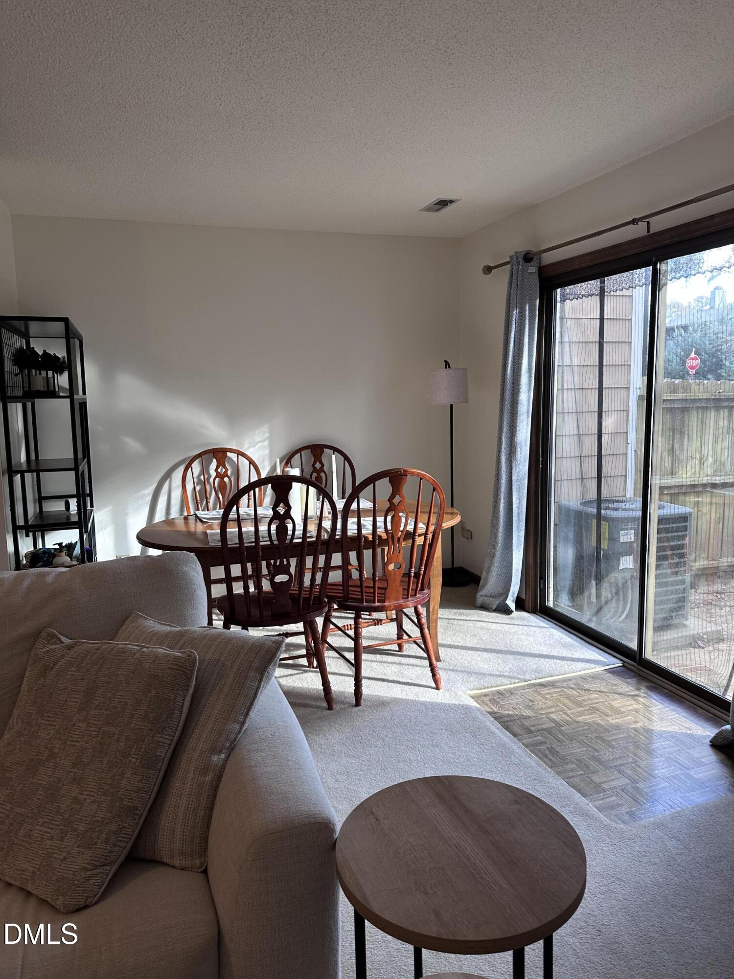 1440 Kent Road Raleigh, NC 27606 - Photo 6 of 21 a living room with furniture and a floor to ceiling window