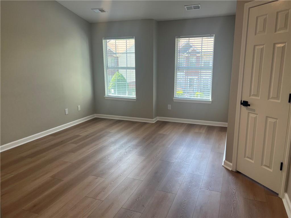 2896 Vining Ridge Terrace Decatur, GA 30034 - Photo 15 of 24 an empty room with wooden floor and windows