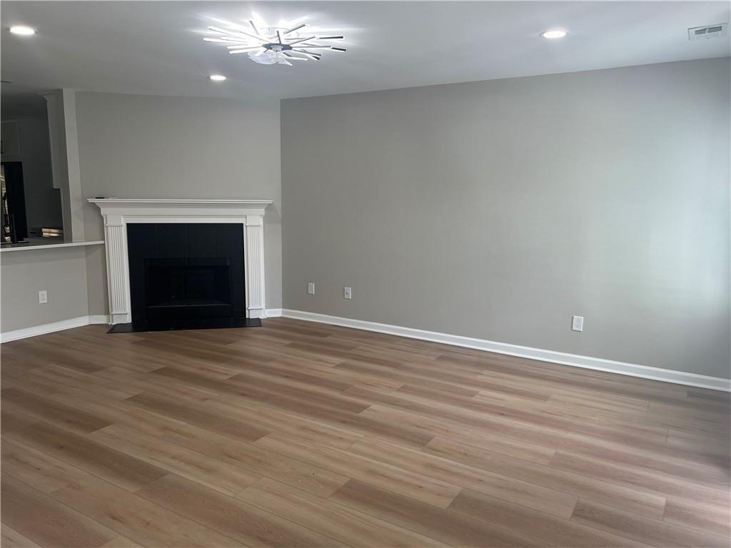 2896 Vining Ridge Terrace Decatur, GA 30034 - Photo 2 of 24 an empty room with wooden floor fireplace and hallway
