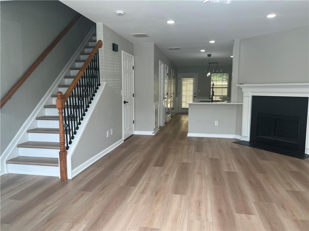 2896 Vining Ridge Terrace Decatur, GA 30034 - Photo 6 of 24 wooden floor in an empty room with a fireplace