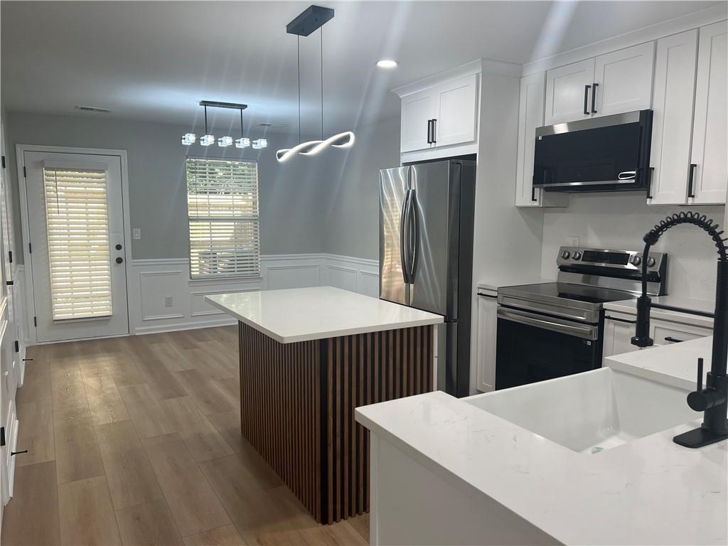 2896 Vining Ridge Terrace Decatur, GA 30034 - Photo 7 of 24 a kitchen with stainless steel appliances a refrigerator sink and stove