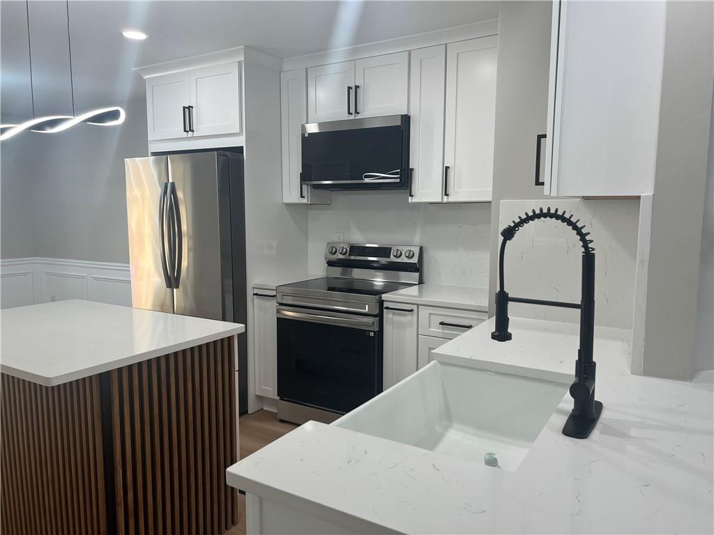 2896 Vining Ridge Terrace Decatur, GA 30034 - Photo 8 of 24 a kitchen with stainless steel appliances granite countertop a refrigerator a sink a stove and microwave