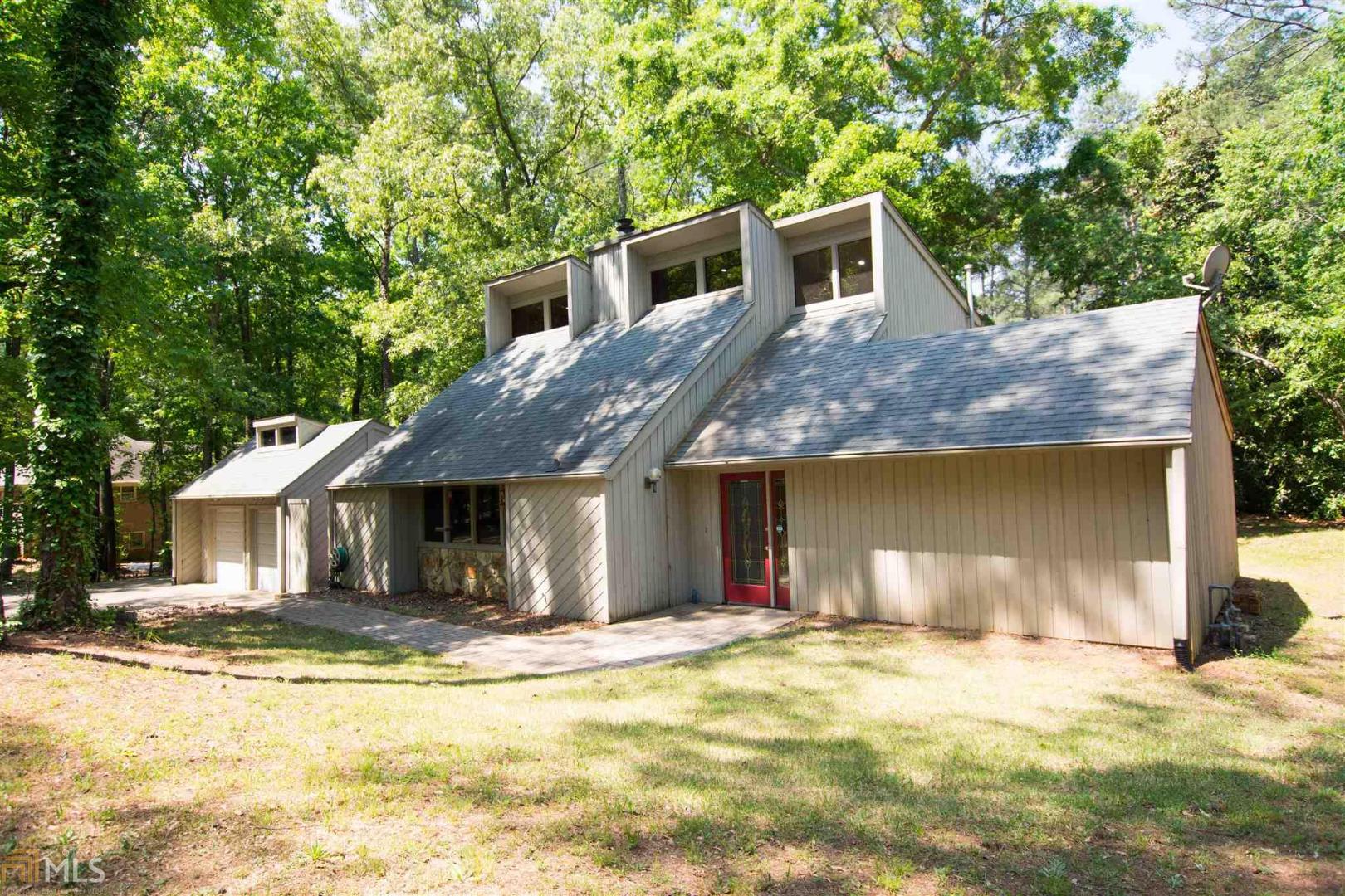 489 Ebenezer Road Fayetteville, GA 30215 - Photo 1 of 1 a front view of a house with a yard and garage