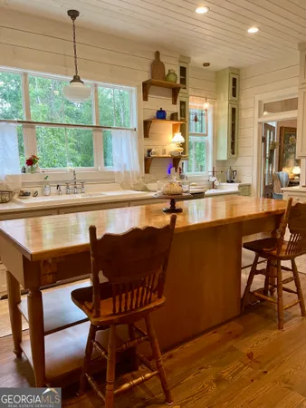 a kitchen with a table chairs sink and cabinets