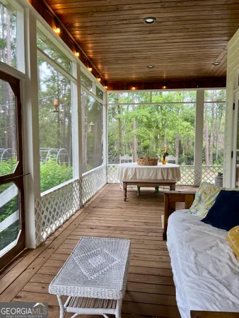 a living room with furniture and large windows