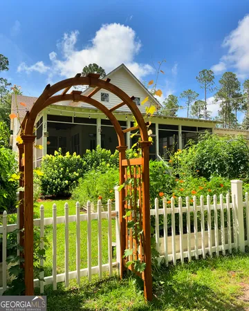 a front view of a house with a garden