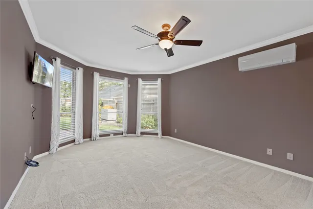 a view of a livingroom with a ceiling fan and window